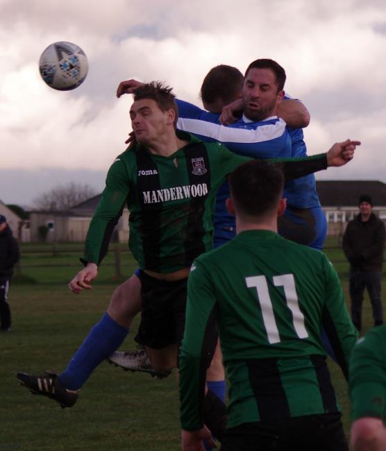 Aerial battle between goal scorers Nicky Woodrow and Richard Hughes in the mouth-watering Senior Cup quarter-final clash between Merlins Bridge and Hakin United